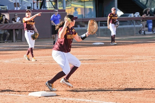Female Infielder Throwing Ball Mid Game